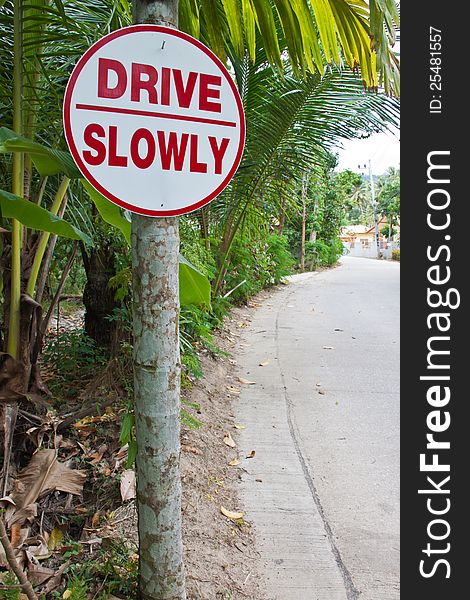 A sign asking drivers to Please Drive Slowly. A sign asking drivers to Please Drive Slowly