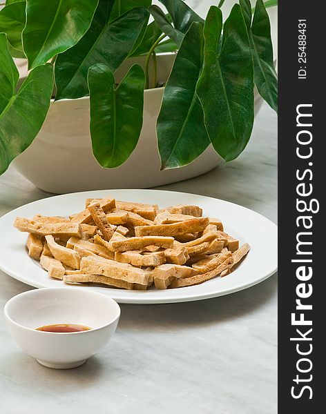 FRIED TOFU WITH SAUCE ON MARBLE TABLE. FRIED TOFU WITH SAUCE ON MARBLE TABLE