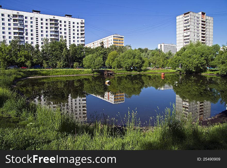 A small pond in a sunny summer morning (Moscow, Russia). A small pond in a sunny summer morning (Moscow, Russia)