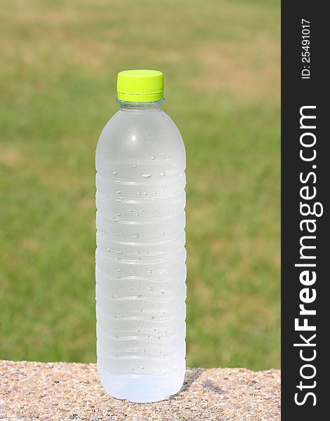 A Bottle of water with green background