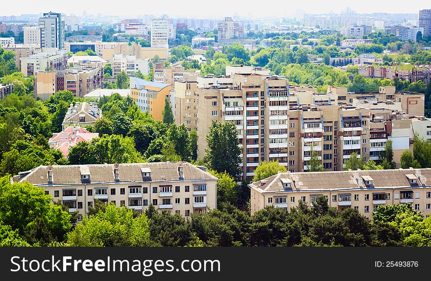 Buildings in a city in an environment of green trees. Buildings in a city in an environment of green trees