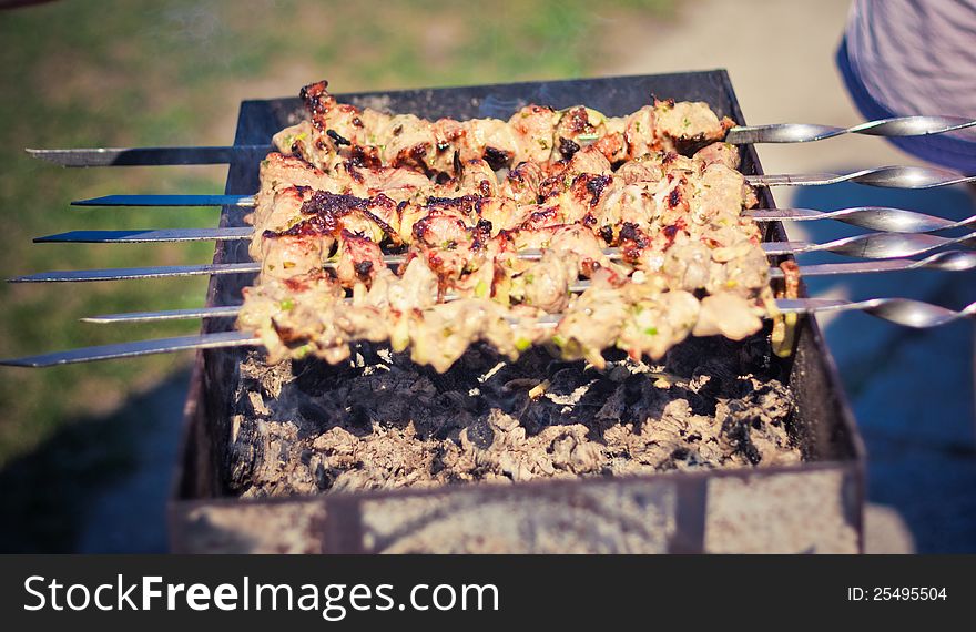 Shish kebab in process of cooking on open fire