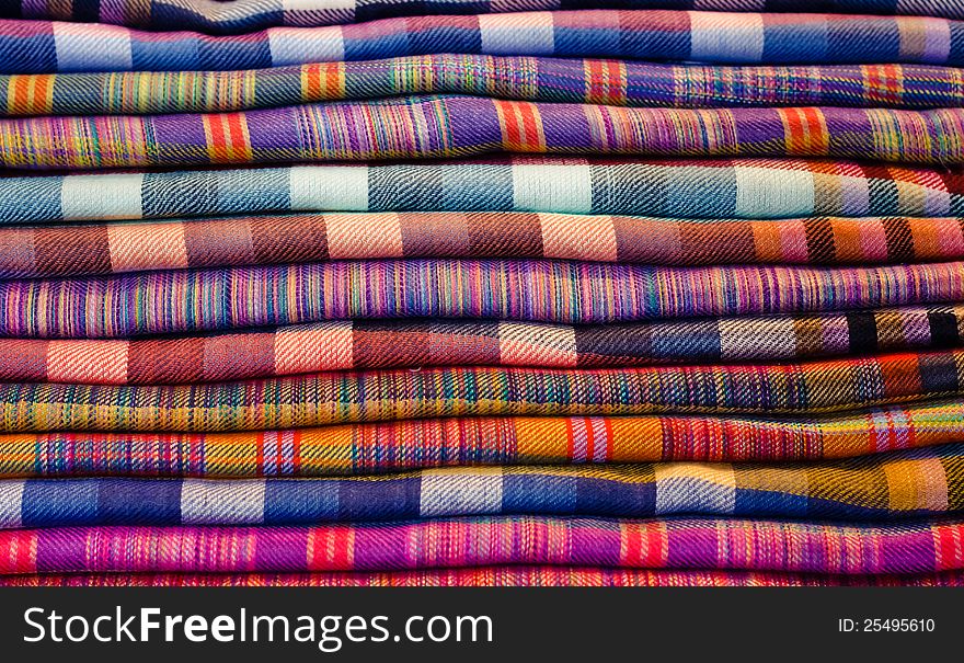Stack Of Colorful Fabrics At Market