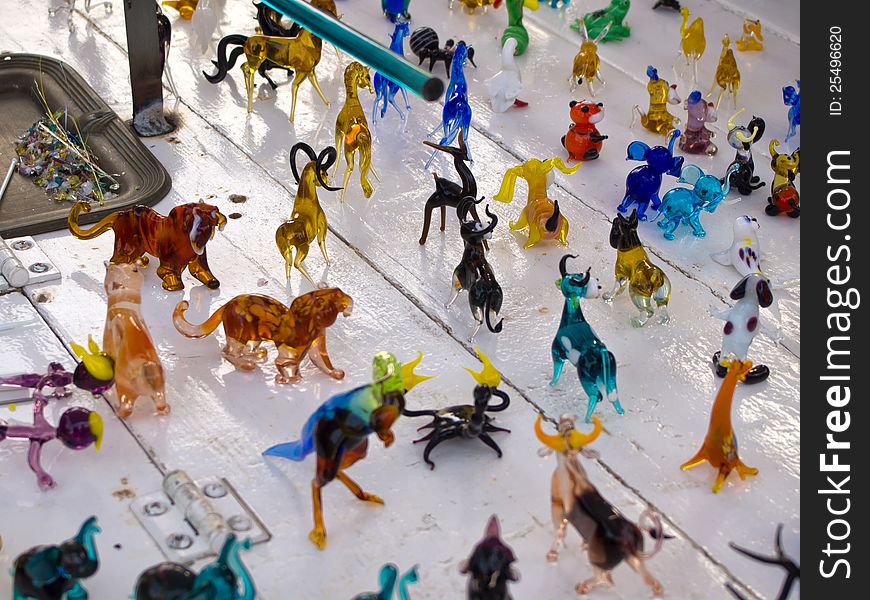 Colorful beautiful glass craft small animals figurines sculptures on display. Colorful beautiful glass craft small animals figurines sculptures on display