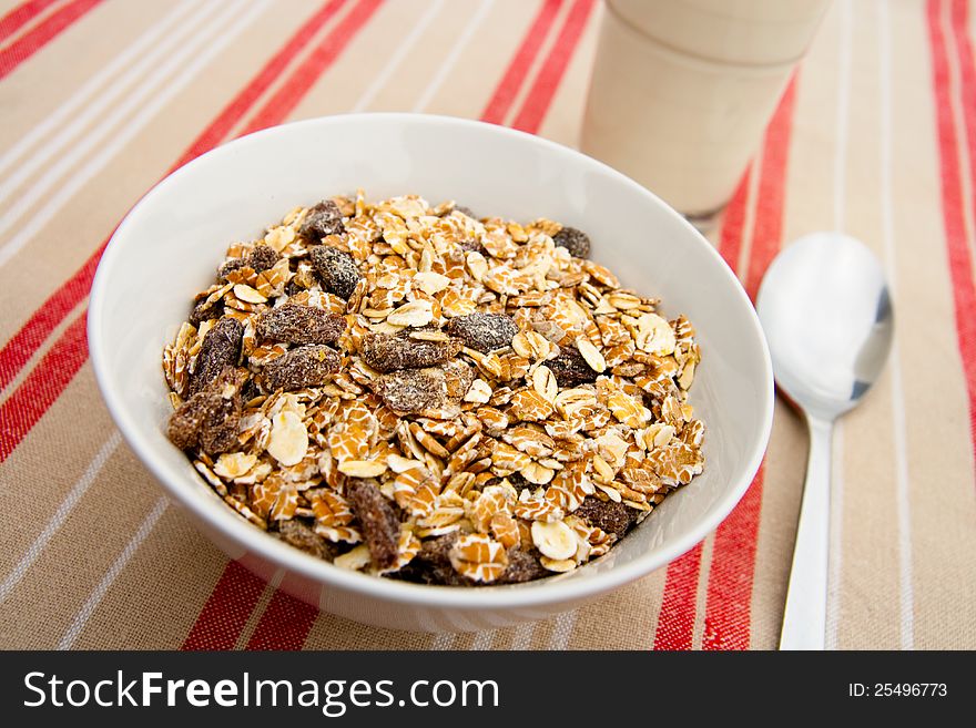 Bowl of muesli with a glass of milk. Bowl of muesli with a glass of milk