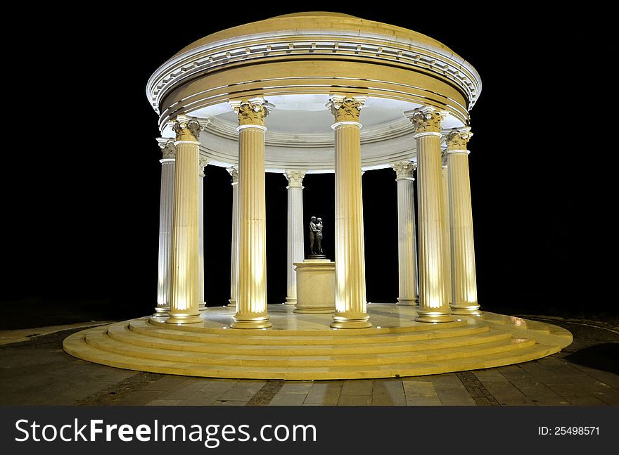 Monument at night with men and woman sculpture. Monument at night with men and woman sculpture