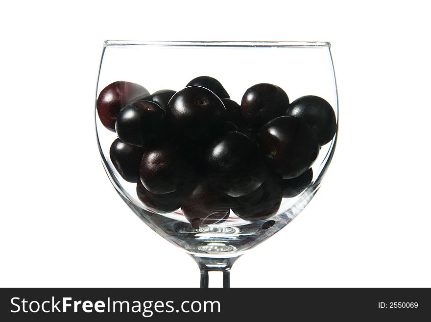 Cup with little dark fruits. Cup with little dark fruits