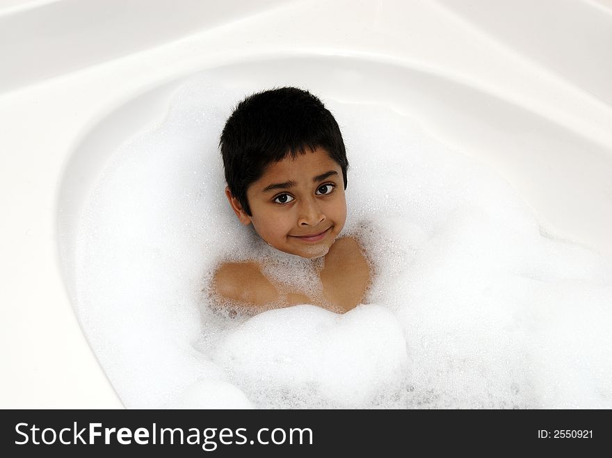 A happy kid enjoying his bubble batch. A happy kid enjoying his bubble batch