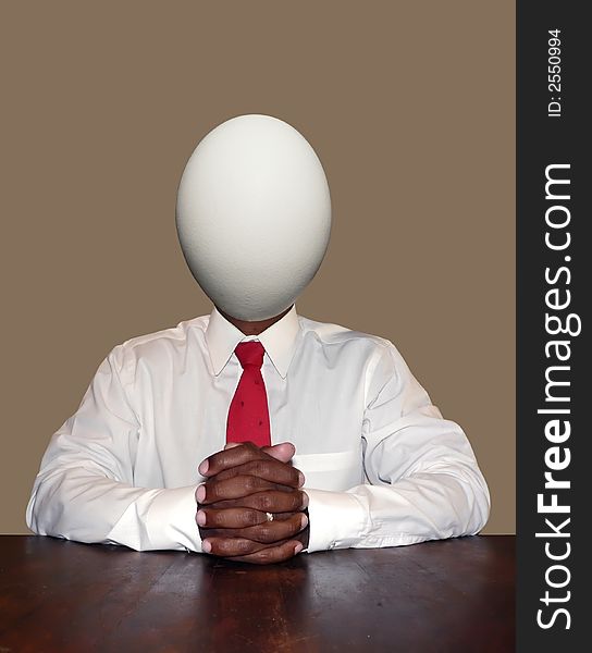 Unintelligent and dumb businessman personality concept photo manipulation depicting a egg for a head sitting at a desk ready for a meeting. isolated over a neutral colored background. clipping path included. Unintelligent and dumb businessman personality concept photo manipulation depicting a egg for a head sitting at a desk ready for a meeting. isolated over a neutral colored background. clipping path included