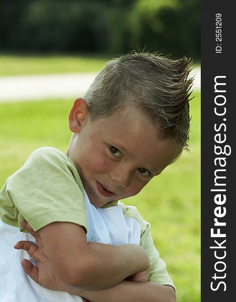 Young boy with cool hair grinning