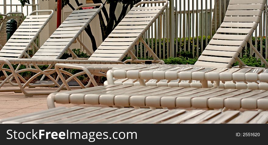 Beach resort poolside lounge chairs. Beach resort poolside lounge chairs