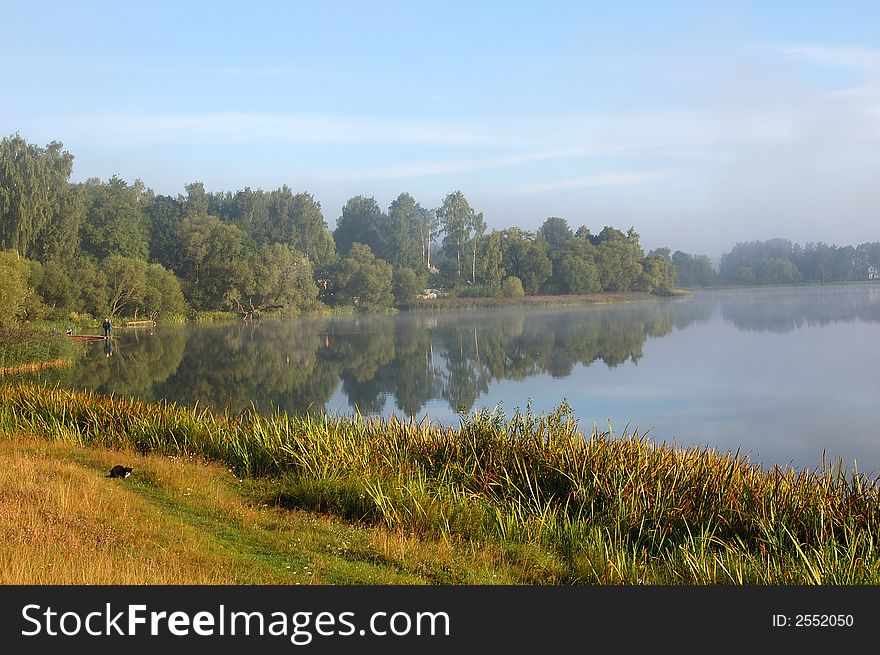 Lake and trees in the foreground in the morning. Lake and trees in the foreground in the morning