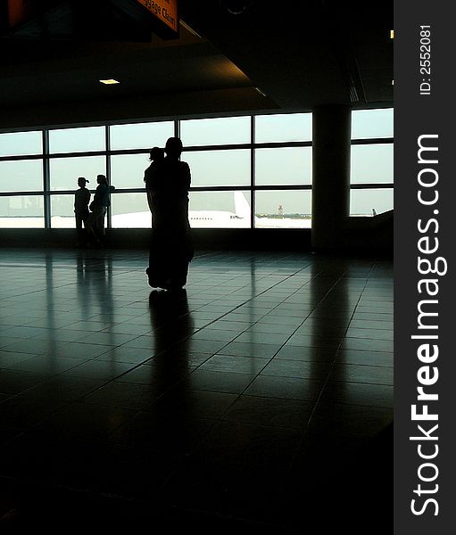 Mother and Child Watching Airplanes From Departure Area of Airport