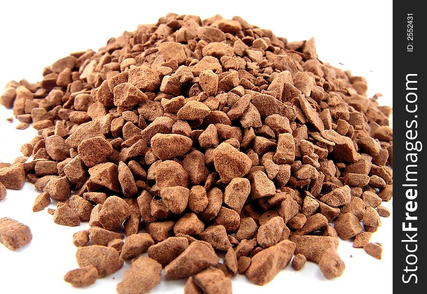 The heap of ground coffee, is photographed close up on a white background.