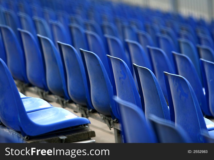 The blue chairs in the tribune