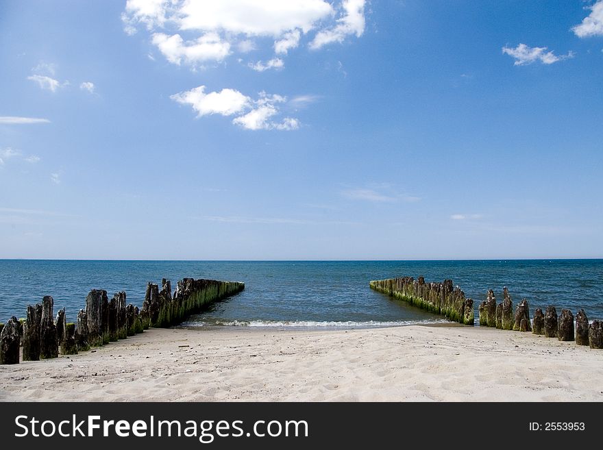 The remains of a jetty, two lines of wooden pilings leading deep into the sea (ocean), copy space, blue sky with some white clouds.

<a href='http://www.dreamstime.com/baltic-sea-scenics.-seaside-towns-and-villages-as-well.-rcollection3976-resi208938' STYLE='font-size:13px; text-decoration: blink; color:#FF0000'><b>MORE BALTIC PHOTOS »</b></a>. The remains of a jetty, two lines of wooden pilings leading deep into the sea (ocean), copy space, blue sky with some white clouds.

<a href='http://www.dreamstime.com/baltic-sea-scenics.-seaside-towns-and-villages-as-well.-rcollection3976-resi208938' STYLE='font-size:13px; text-decoration: blink; color:#FF0000'><b>MORE BALTIC PHOTOS »</b></a>