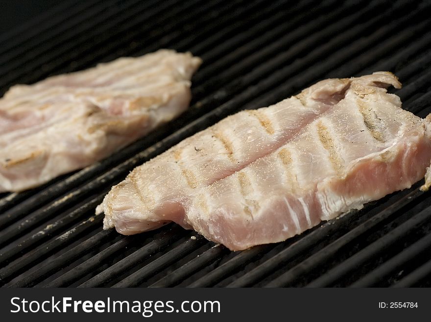 Pork chops on the grill.  Grill marks and close up detail. Pork chops on the grill.  Grill marks and close up detail