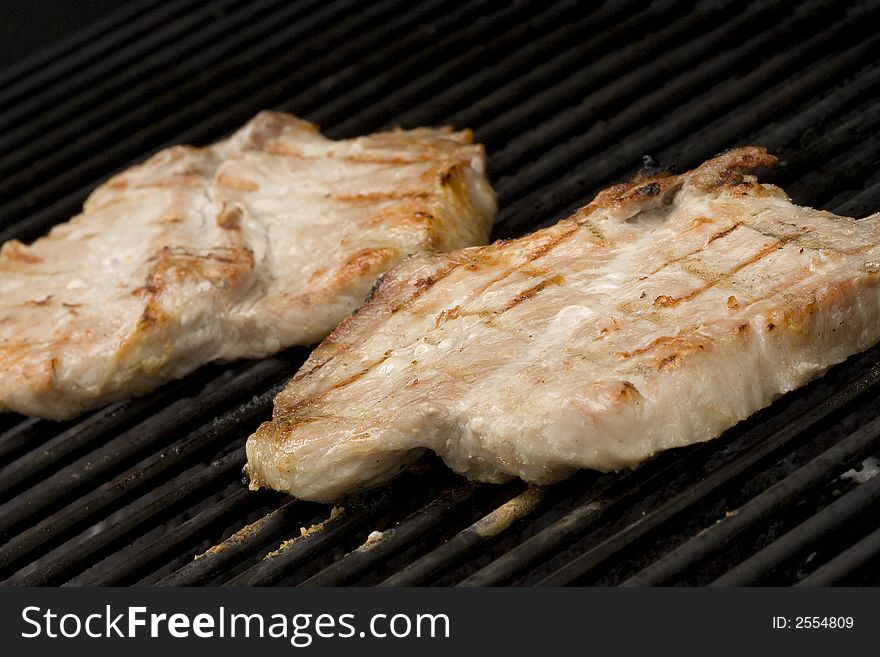 Pork chops on the grill.  Grill marks and close up detail. Pork chops on the grill.  Grill marks and close up detail