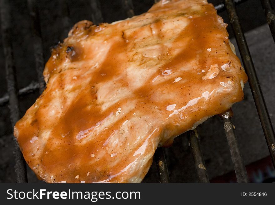 Pork chops on the grill. Grill marks and close up detail. Pork chops on the grill. Grill marks and close up detail