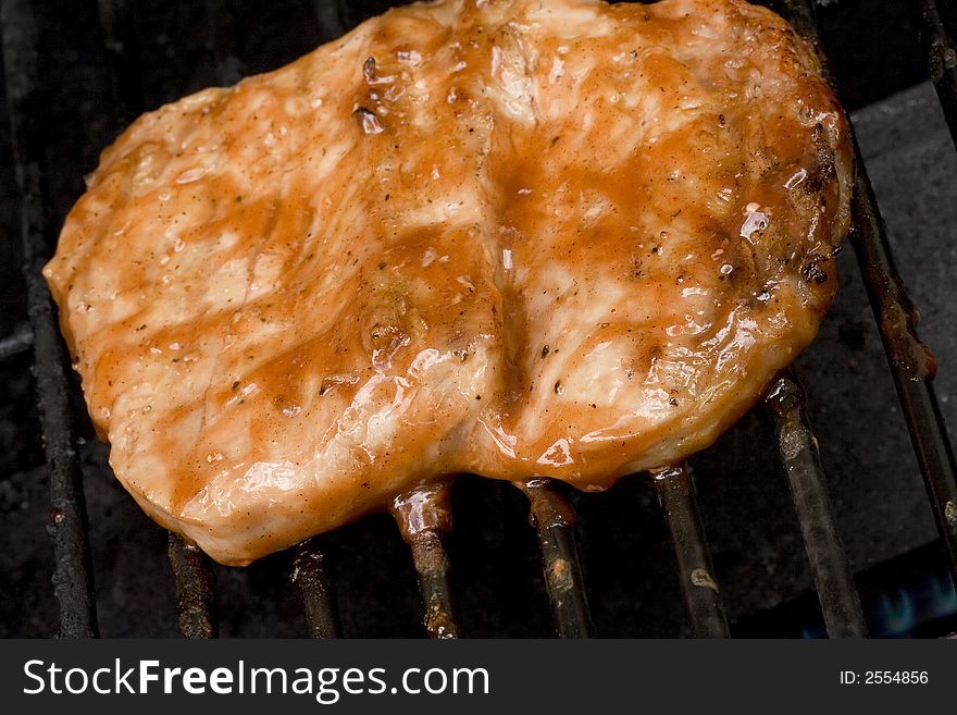 Pork chops on the grill.  Grill marks and close up detail. Pork chops on the grill.  Grill marks and close up detail