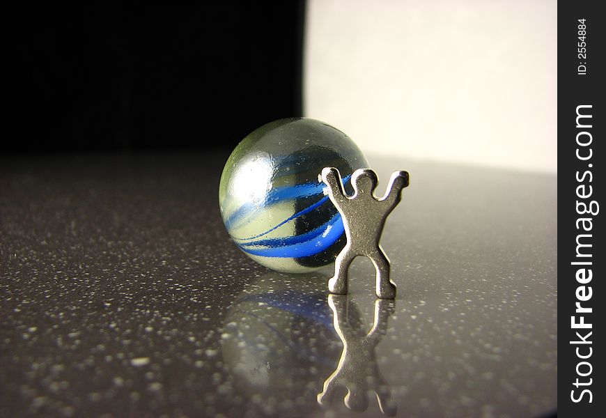 A yin yang marble with metal human figure. A yin yang marble with metal human figure.