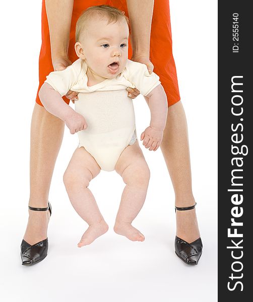 Young mother holding her sleepy baby boy. White background, front view. Young mother holding her sleepy baby boy. White background, front view