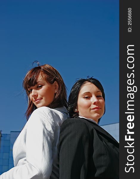 Portrait of two young women opposed back-to-back. Portrait of two young women opposed back-to-back