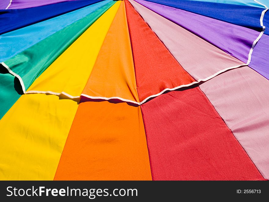 A very colorful rainbow patio umbrella. A very colorful rainbow patio umbrella