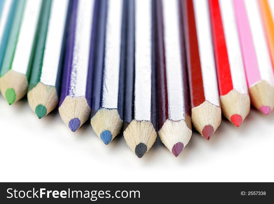 Colored wooden Crayons. Isolated on white background. Soft focus.