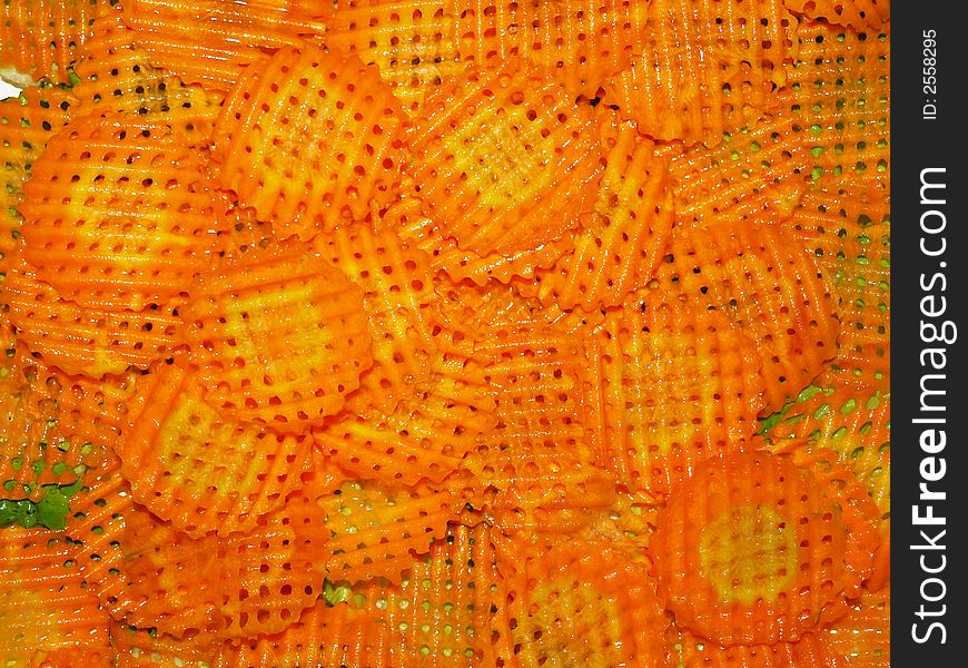 Slices of decorative carrots as prepared for garnishing salad. Slices of decorative carrots as prepared for garnishing salad.