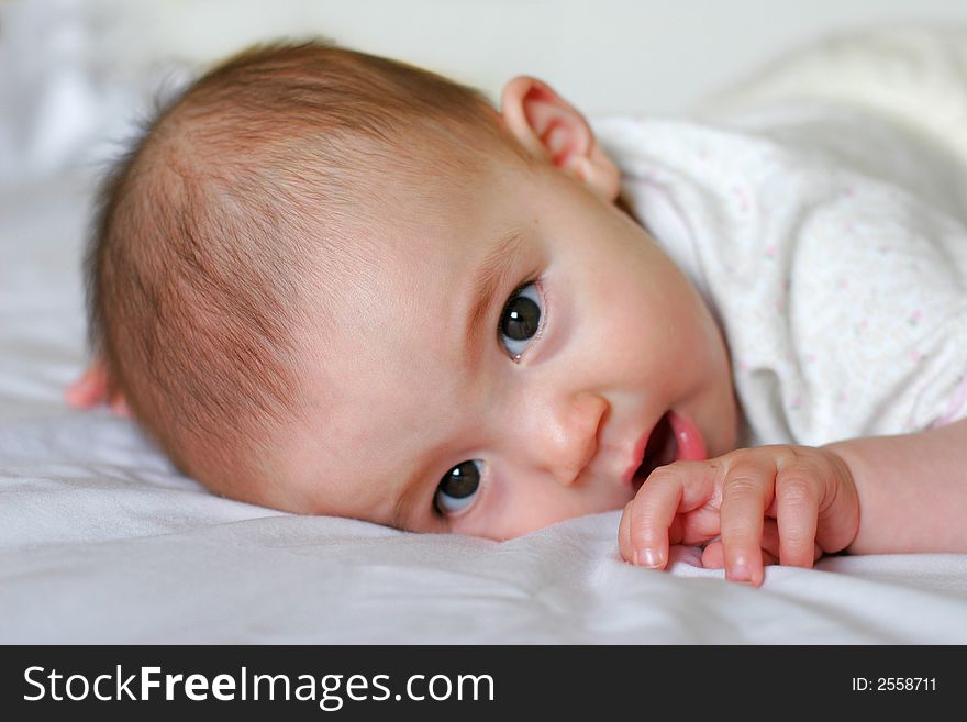 Cute 6 Months old mixed baby girl trying to stand up. Cute 6 Months old mixed baby girl trying to stand up