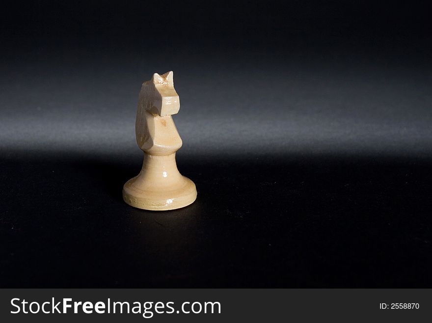 Isolated hand made wood chess horse piece. Isolated hand made wood chess horse piece