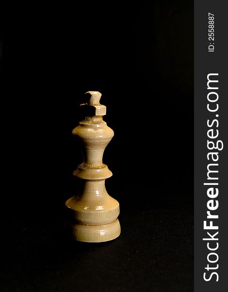 White chess king piece in shadow. White chess king piece in shadow