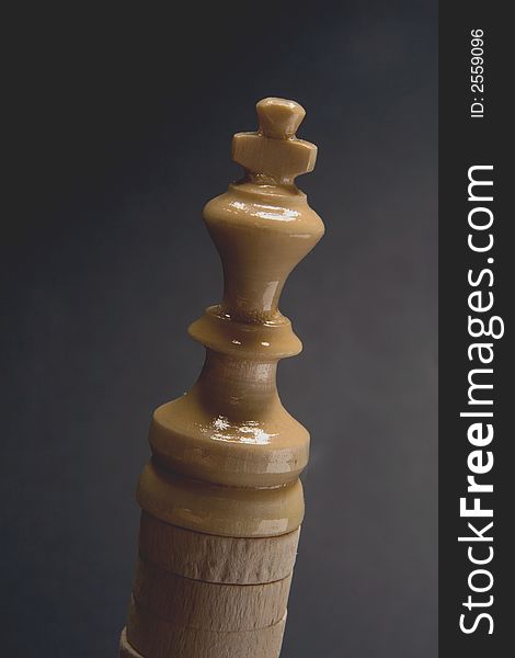 Shinny white chess king piece detail. Shinny white chess king piece detail