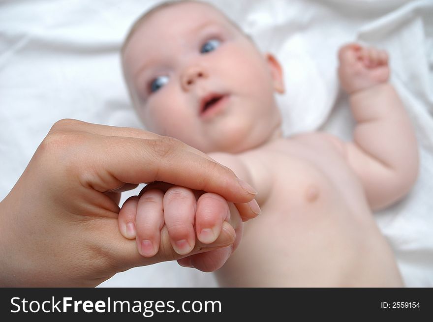 Mother massaging hands of her baby. Mother massaging hands of her baby