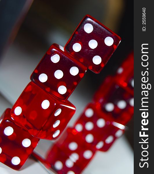 Red dice close ups infront of a mirror on top of each other