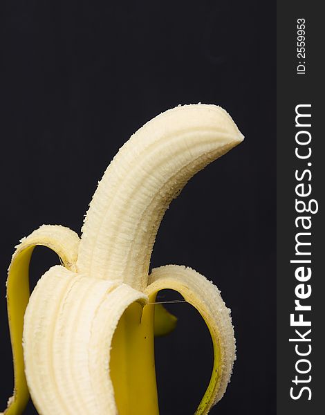 Peeled banana isolated on black
