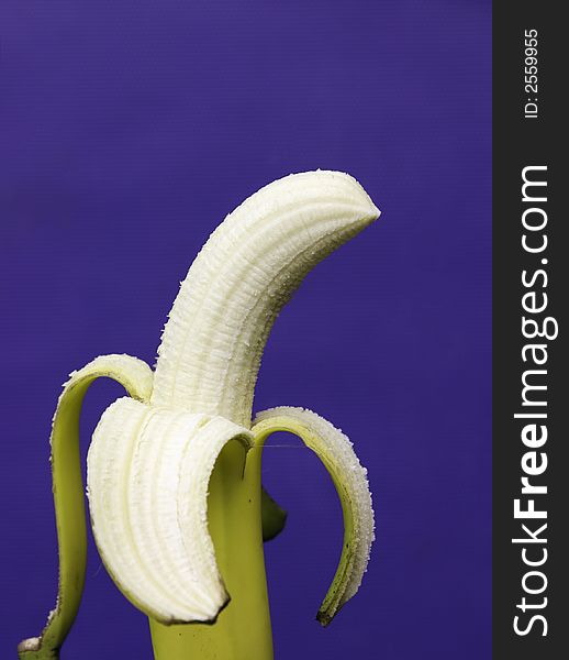 Peeled banana with blue background