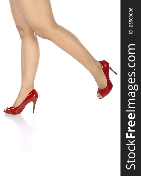 Woman wearing red shoes isolated over white background