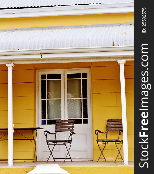 Porch of Cape Duch house with two garden chairs. Porch of Cape Duch house with two garden chairs