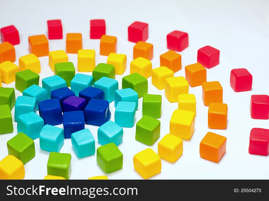 Colorful cubes with paste on background