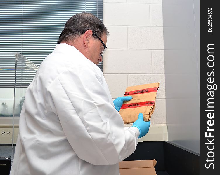 Police forensic investigator working on evidence in the lab.