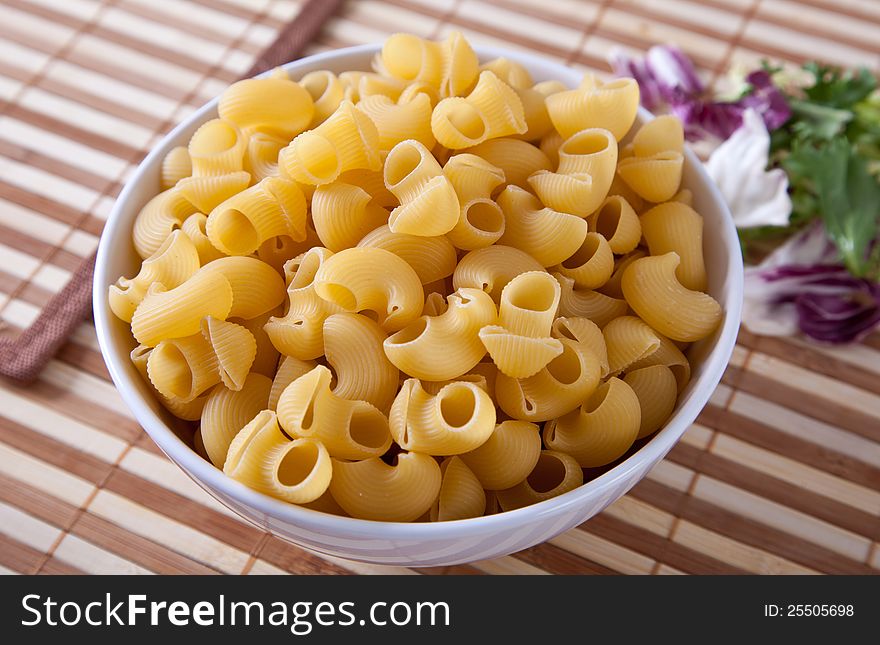 Delicious Uncooked Pasta in a Serving Bowl. Delicious Uncooked Pasta in a Serving Bowl