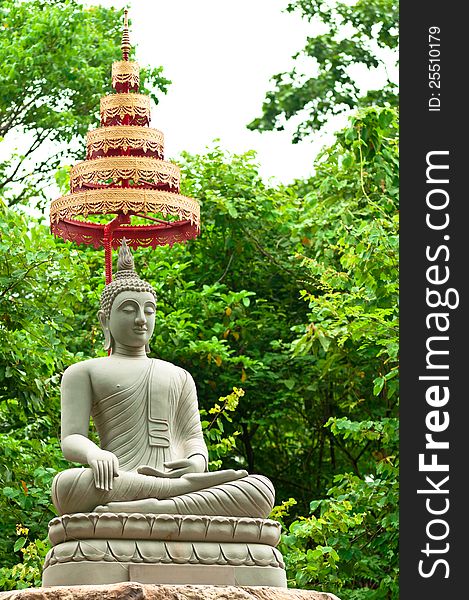 Buddha Image Made From Sand Stone with Trees