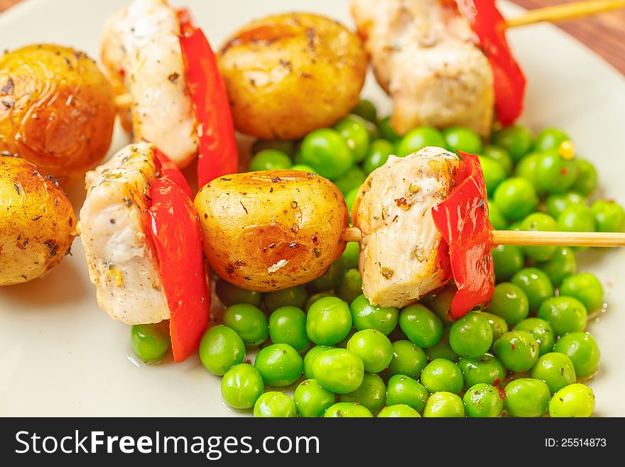 Grilled chicken with potatoes and peas, close up. Grilled chicken with potatoes and peas, close up