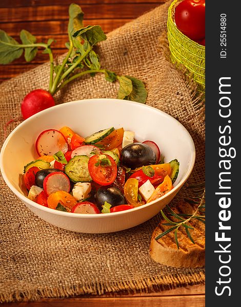 Vegetable food : fresh tomato salad in white bowl with fresh herbs