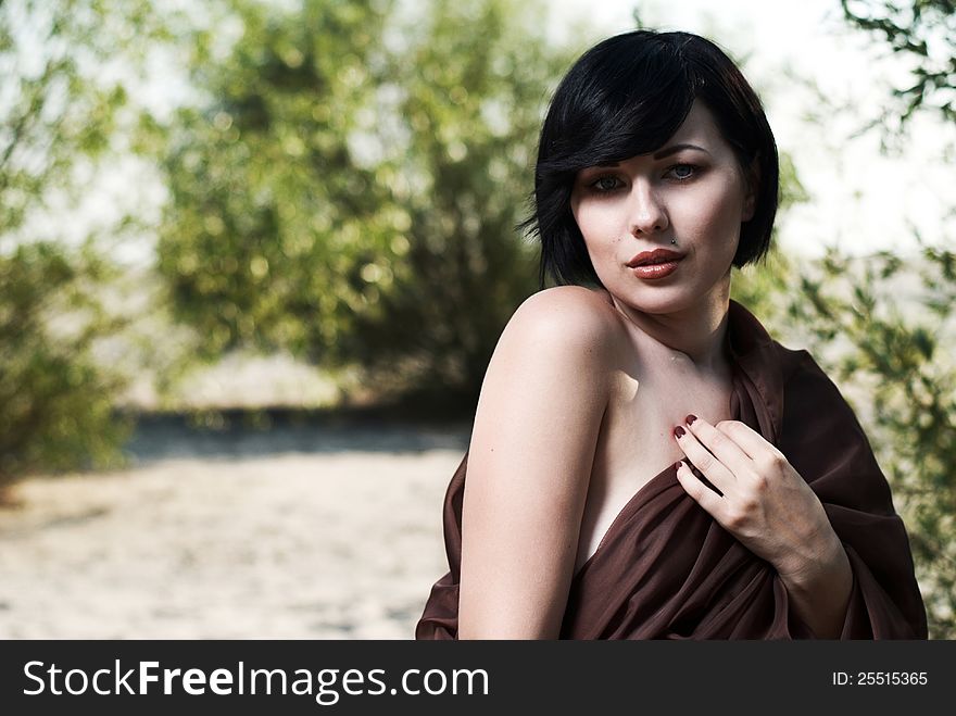 Girl posing in a tree shade