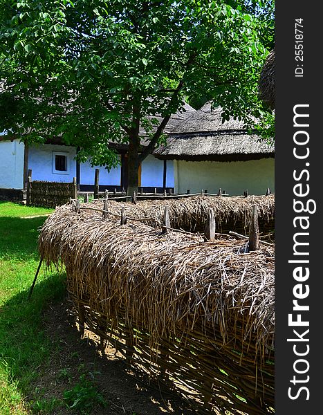 Image of a straw fence in a village