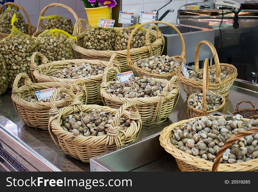 Fresh Mussels in a market. Different kind of mussels are put on sell in basket. This is a spanish market in Valencia