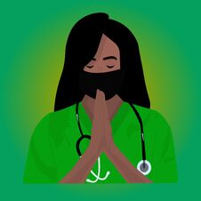 Portrait Of A Beautiful Black Female Doctor Praying In A Green Uniform. Black Female Doctor Praying. Black Doctor Portrait. Young Royalty Free Stock Photo